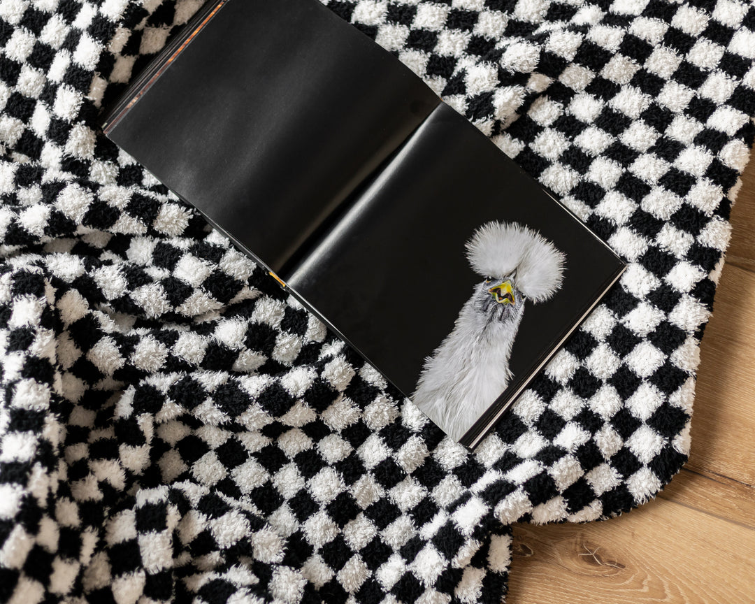 Black wallet with a chicken design on a black and white checkered fabric