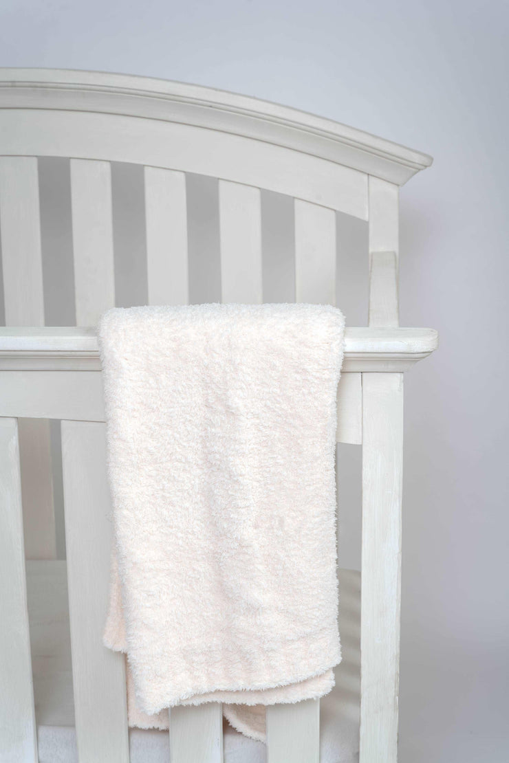 cable knit sea salt toddler blanket on crib
