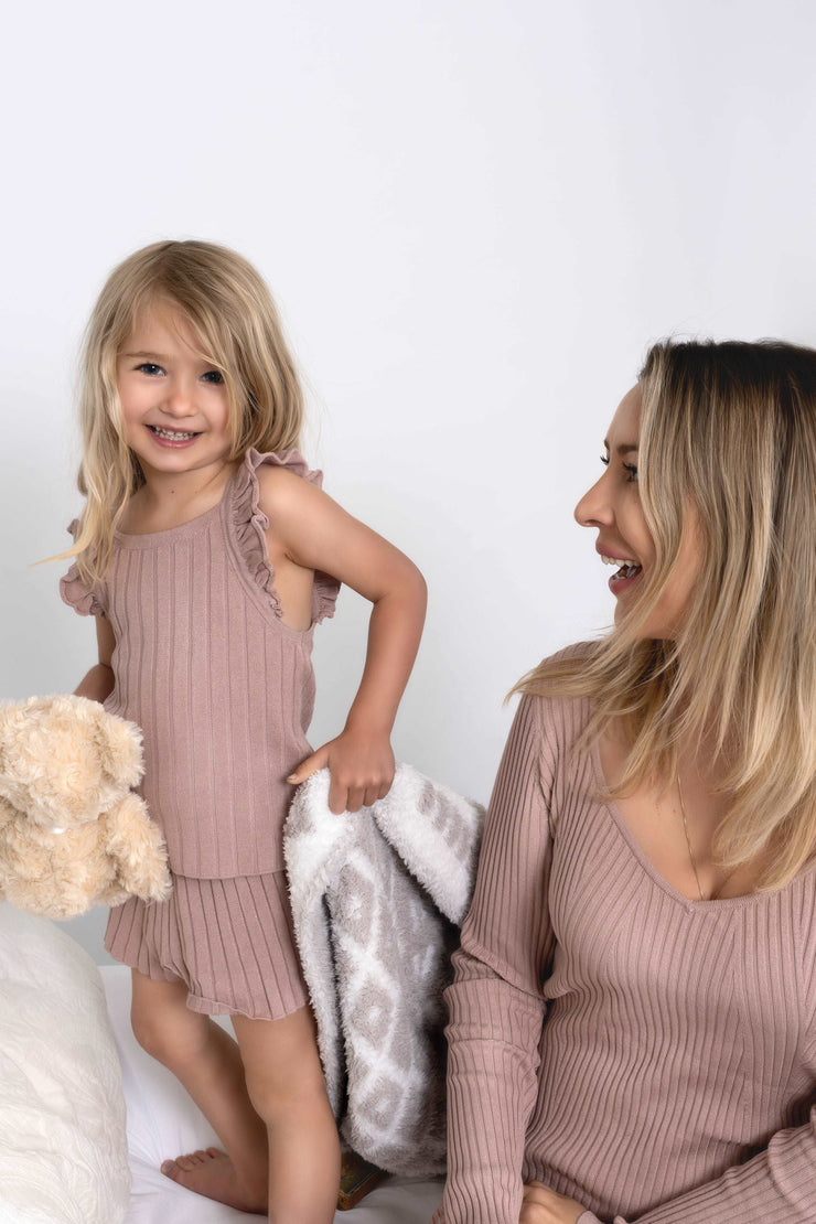 diamond point beige and white extended throw blanket on a bed with mommy and me