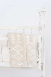 diamond point marshmallow birch lovey baby blanket on a crib
