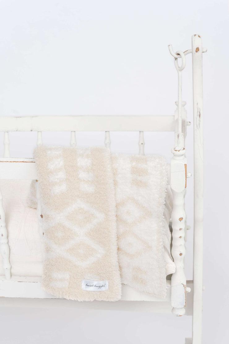 diamond point marshmallow birch lovey baby blanket on a crib
