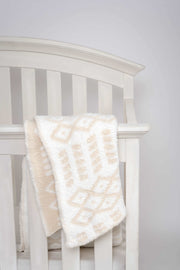 diamond point birch and marshmallow toddler blanket on crib