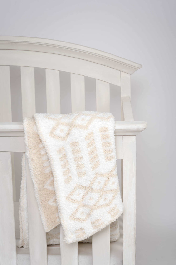 diamond point birch and marshmallow toddler blanket on crib