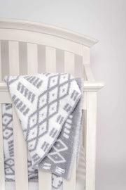 diamond point ultimate grey and white toddler baby blanket on a crib