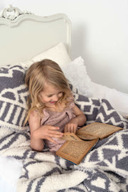 diamond tile baby's breath volcanic glass twin blanket on a  bed with little girl