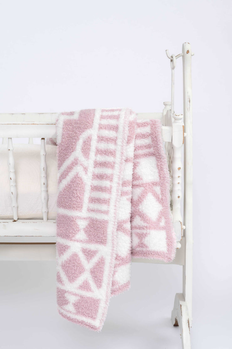 diamond tile pink rose and white toddler baby blanket on a cradle