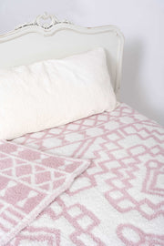 diamond tile rose pink and white twin blanket on bed
